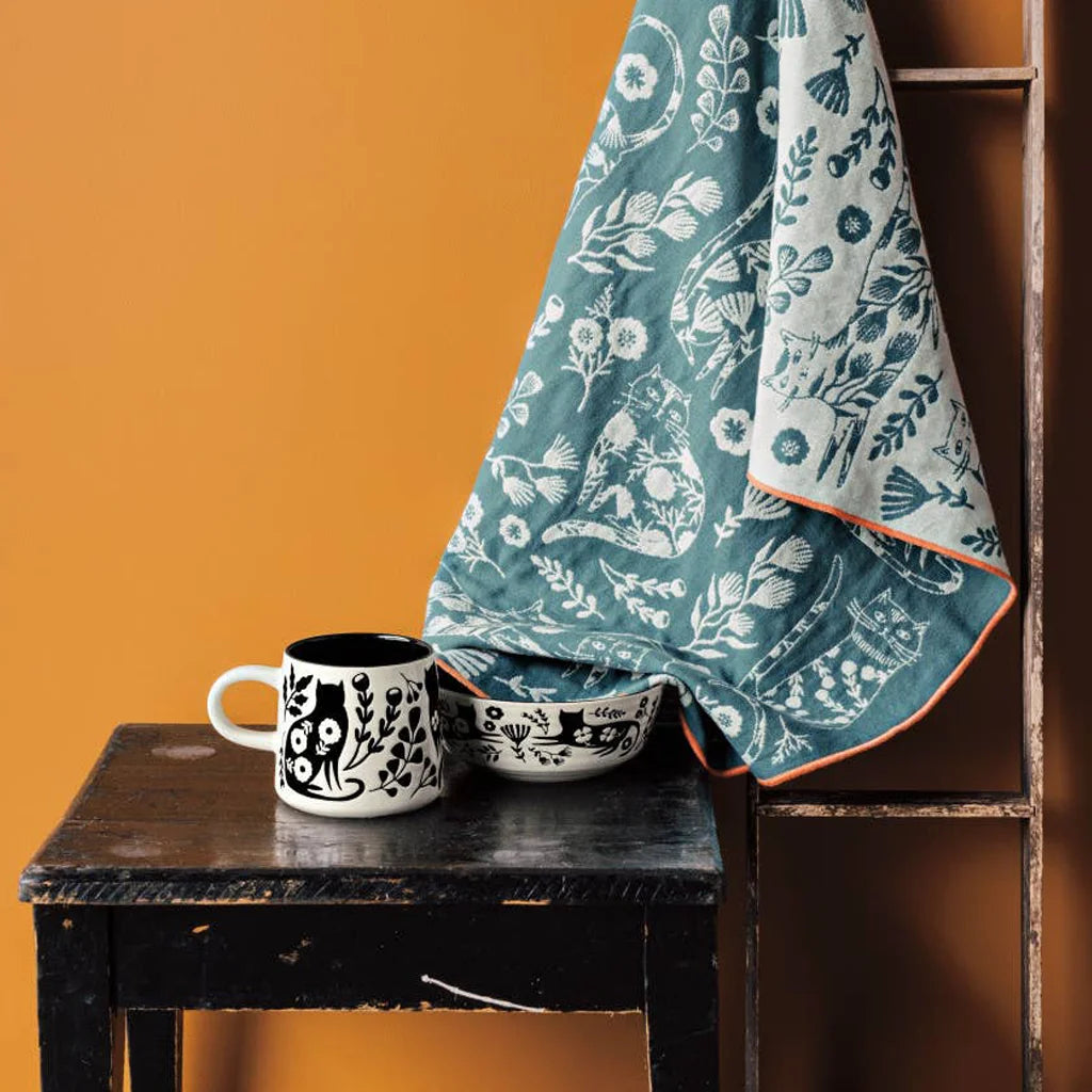 Decorative bowl with black & white floral and cat design on a white background