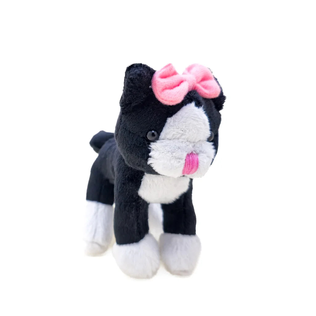 Black and white plush cat toy with a pink bow on a white background
