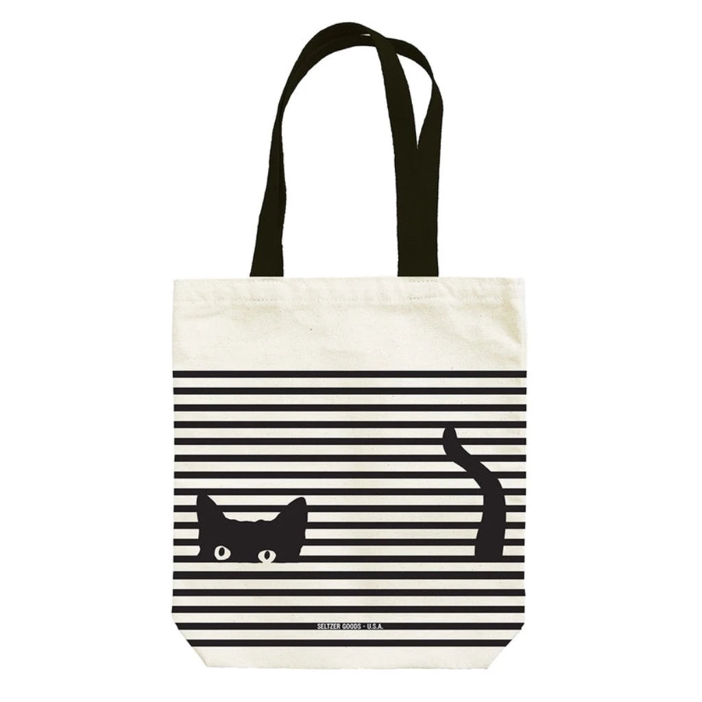 A black and white striped tote bag with an illustration of a cat's face and tail peeking out from the design.